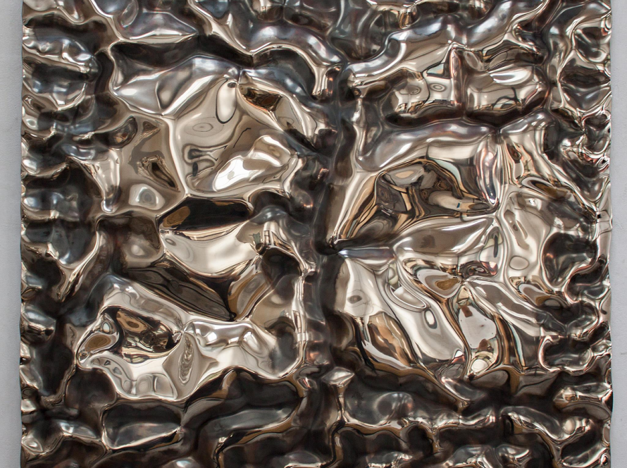 Mirror-polished stainless-steel wall panel by Rado Kirov titled “Tributarius,” 2018; rippled, fluid relief reflecting the room and viewer